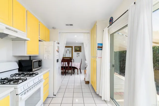 a bedroom with a bed and large windows