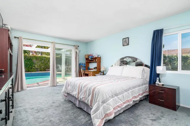 a bedroom with a bed and a tv on the dresser