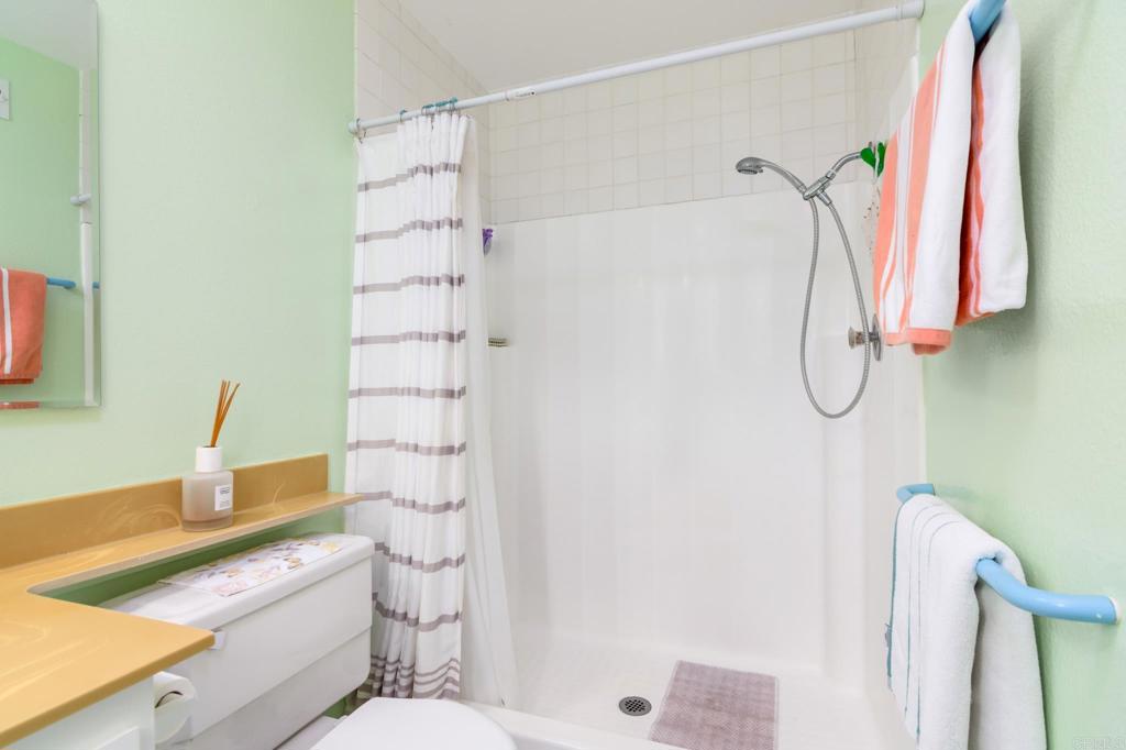 29302 Edgewood Road San Juan Capistrano, CA 92675 - Photo 22 of 57 a bathroom with a granite countertop sink a toilet and shower