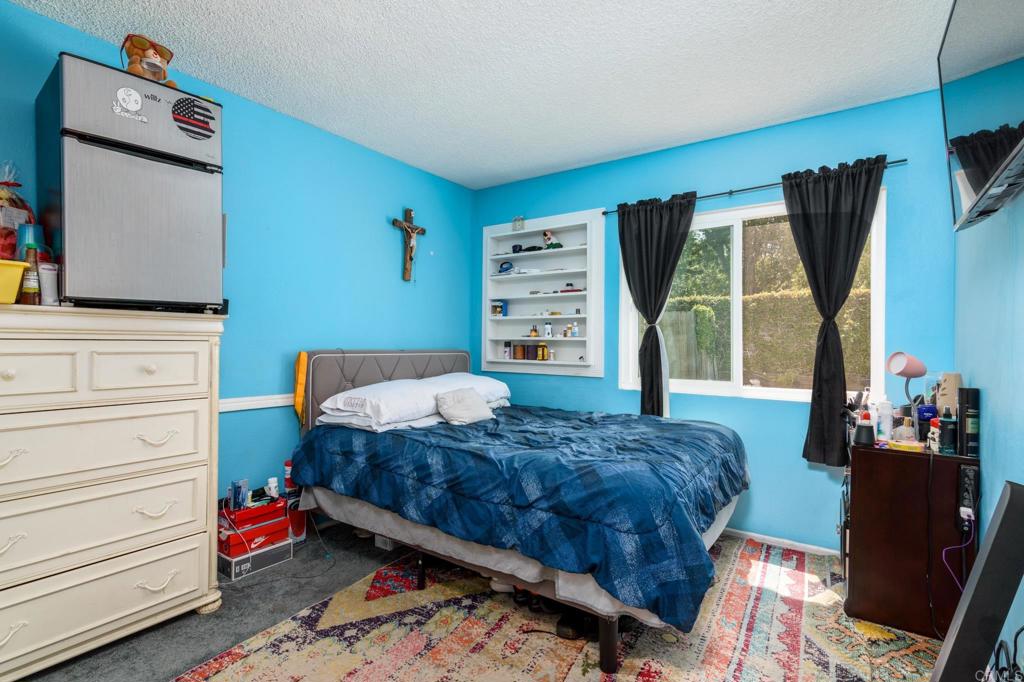 29302 Edgewood Road San Juan Capistrano, CA 92675 - Photo 24 of 57 a bedroom with a bed and wooden floor