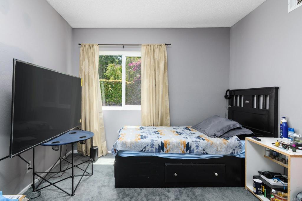 29302 Edgewood Road San Juan Capistrano, CA 92675 - Photo 25 of 57 a bedroom with a bed and a flat screen tv