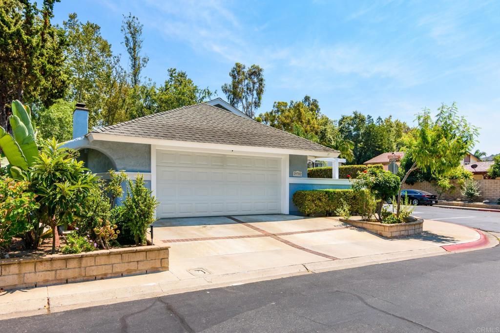 29302 Edgewood Road San Juan Capistrano, CA 92675 - Photo 3 of 57 a front view of a house with a yard and garage