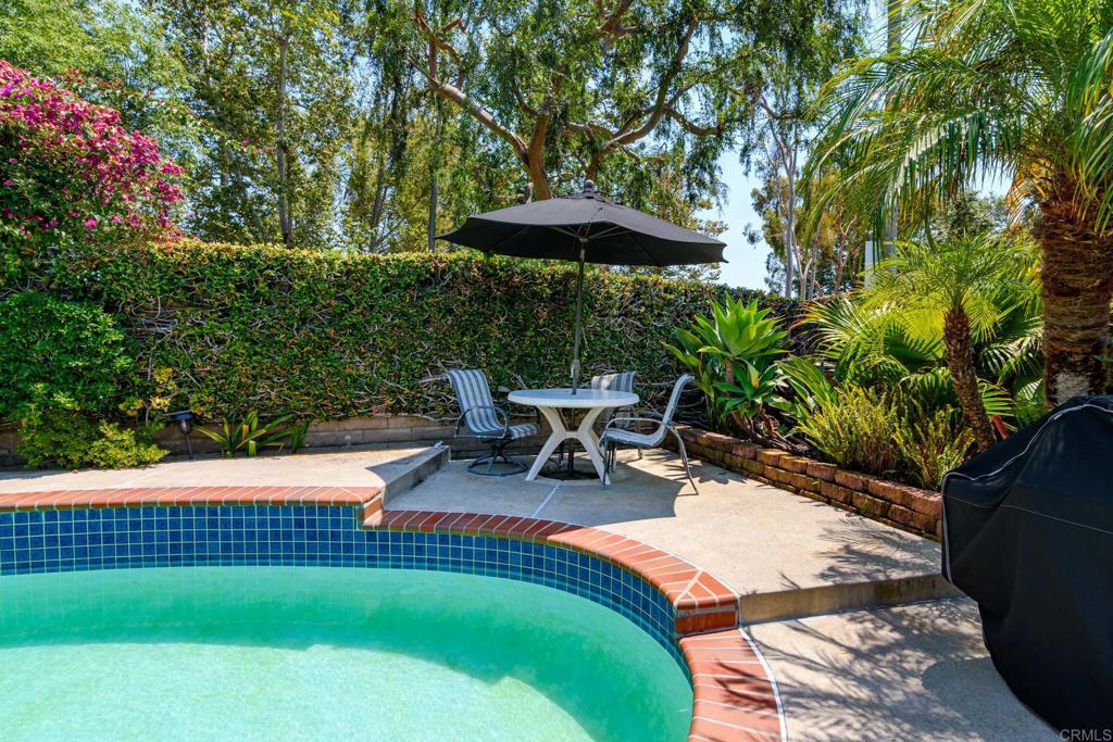 29302 Edgewood Road San Juan Capistrano, CA 92675 - Photo 31 of 57 a backyard of a house with table and chairs under an umbrella
