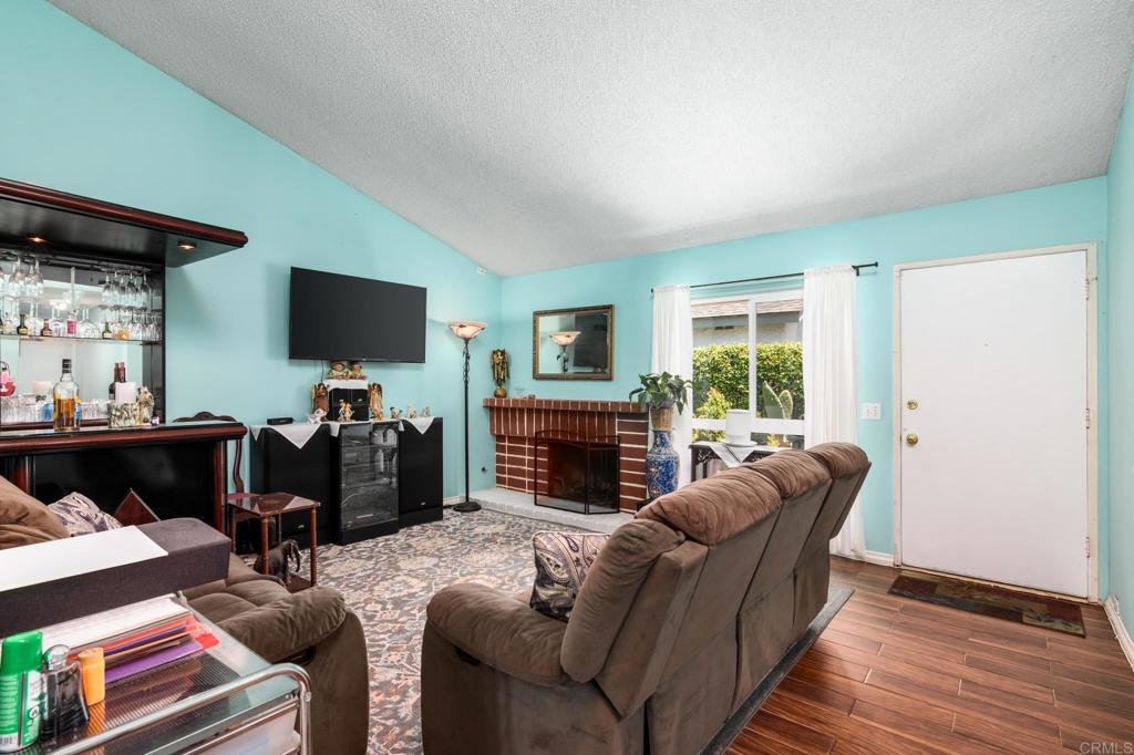 29302 Edgewood Road San Juan Capistrano, CA 92675 - Photo 9 of 57 a living room with furniture a fireplace and a flat screen tv