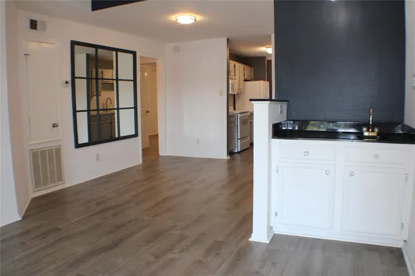 a view of a kitchen cabinets and wooden floor