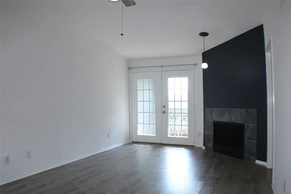a view of entryway with kitchen and wooden floor