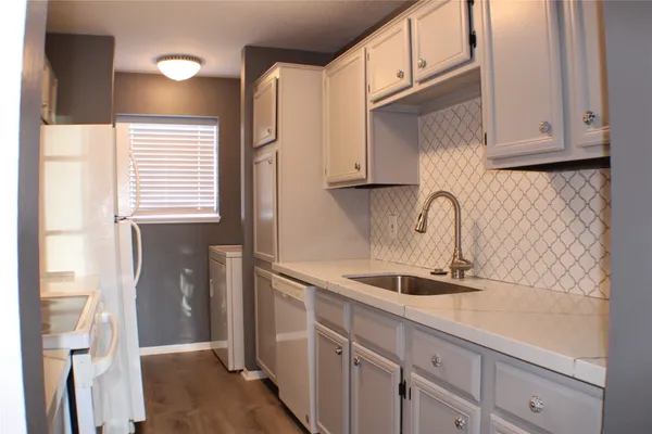 a stove top oven sitting inside of a kitchen
