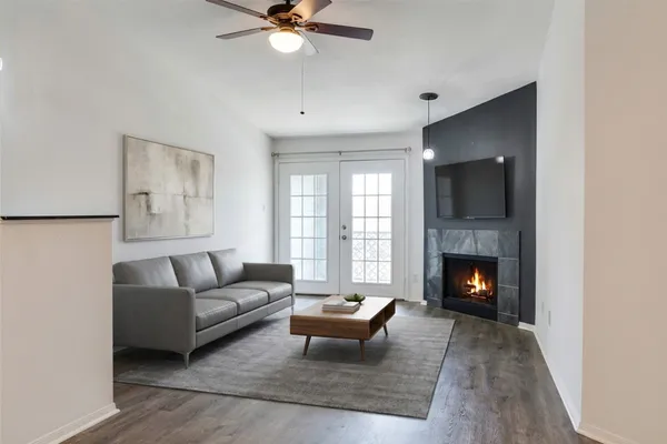 a view of a hallway with wooden floor and cabinet