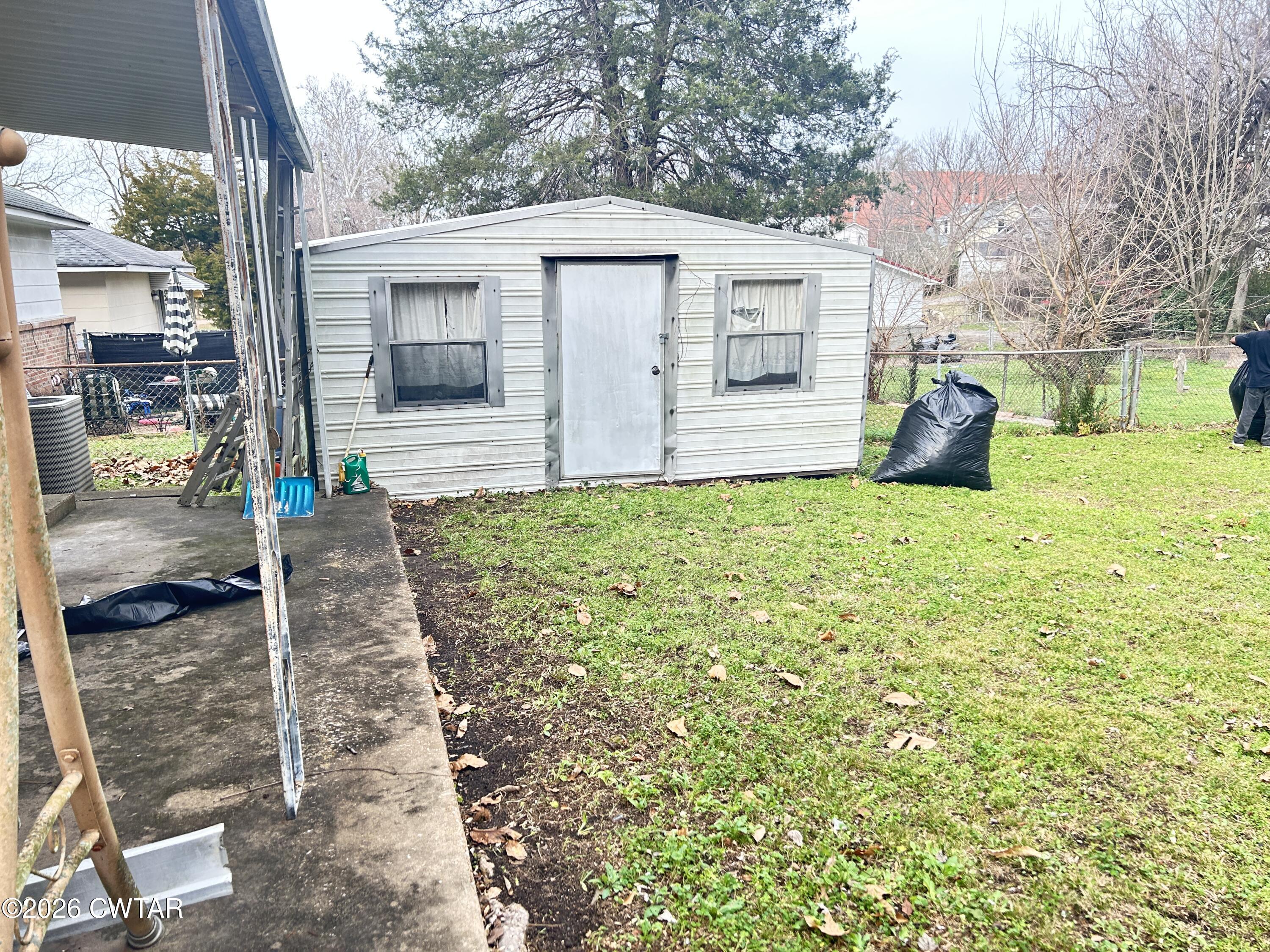 258 Oak Street Jackson, TN 38301 - Photo 22 of 22 a view of a house with backyard and a tree