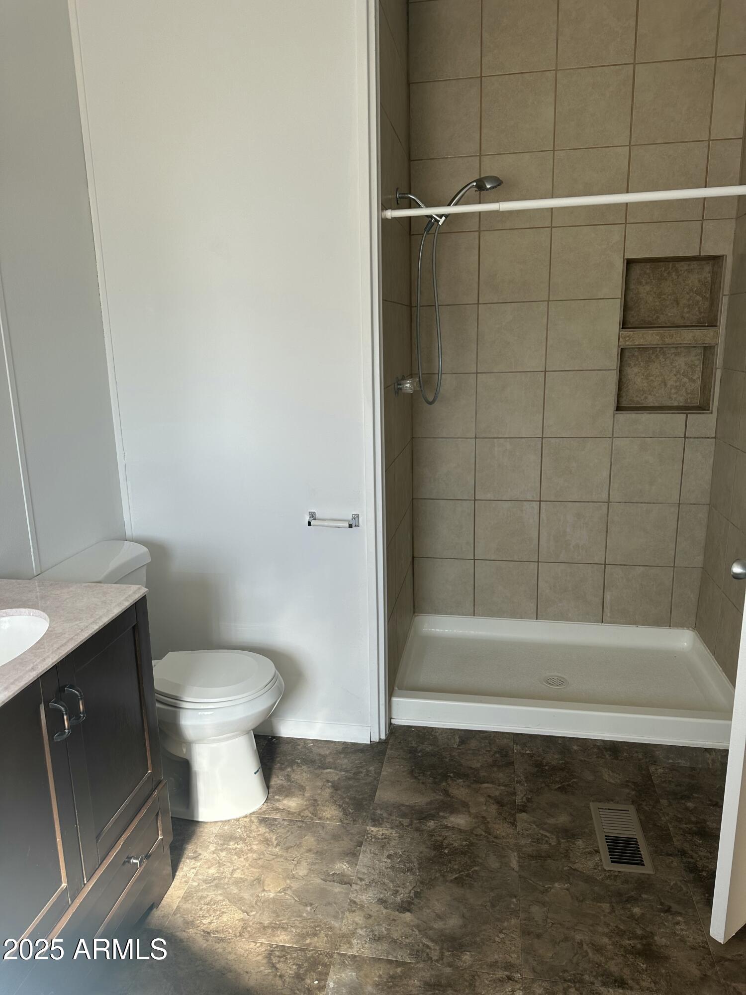 840 North Falton Road Maricopa, AZ 85139 - Photo 13 of 28 a bathroom with a toilet and a shower