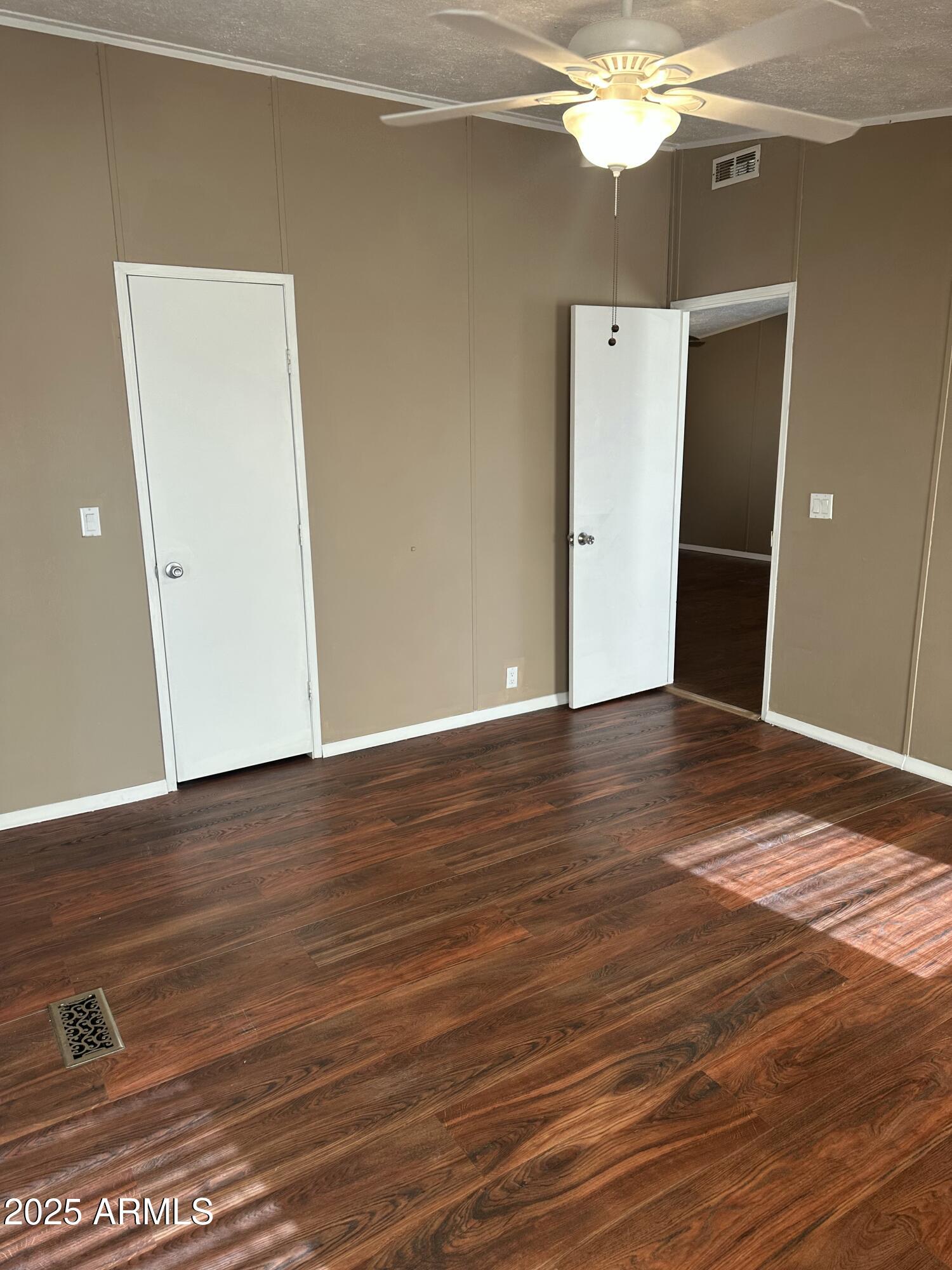 840 North Falton Road Maricopa, AZ 85139 - Photo 14 of 28 a view of a livingroom with wooden floor