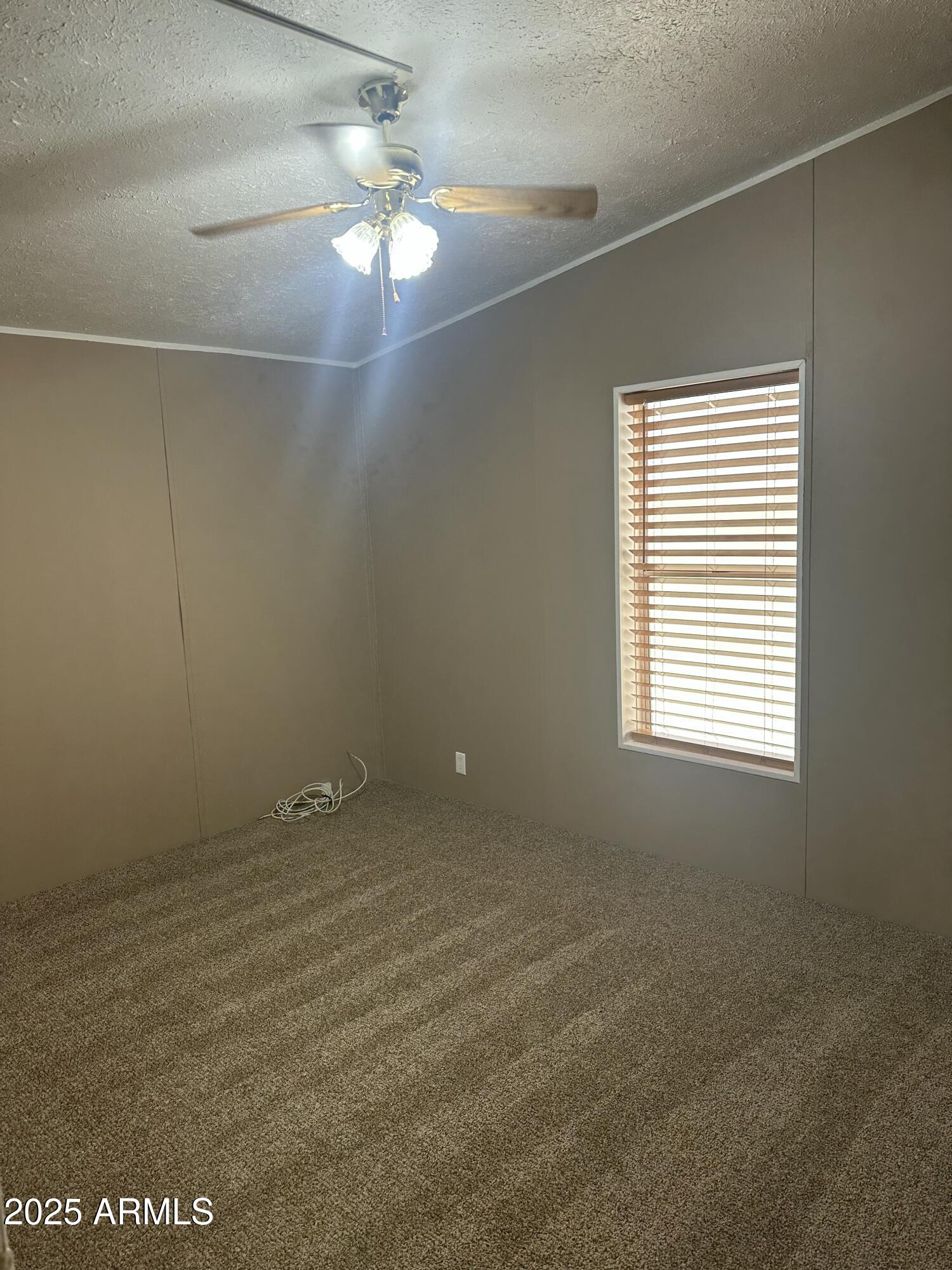 840 North Falton Road Maricopa, AZ 85139 - Photo 17 of 28 a view of an empty room with a window