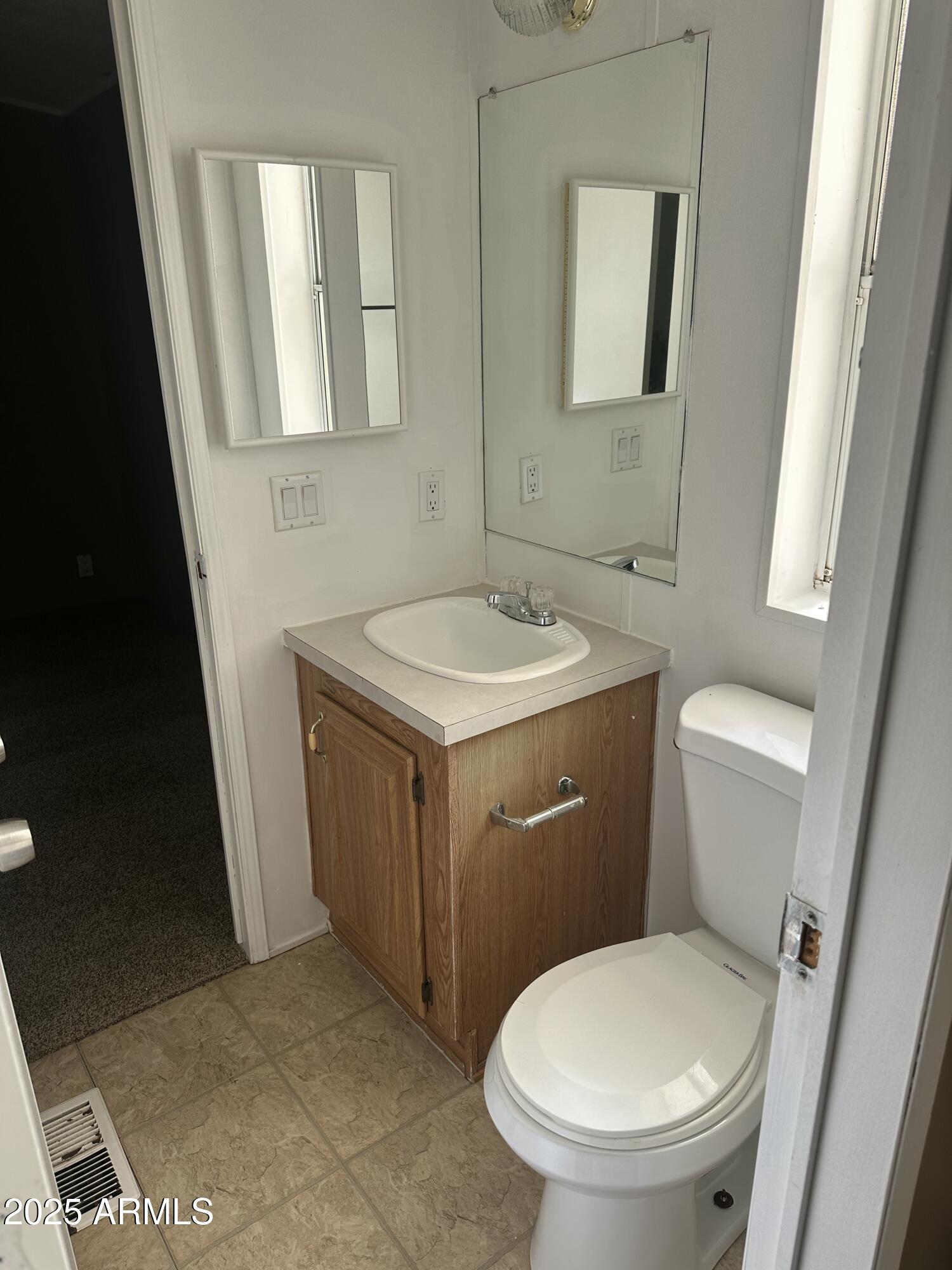 840 North Falton Road Maricopa, AZ 85139 - Photo 20 of 28 a bathroom with a toilet sink and mirror
