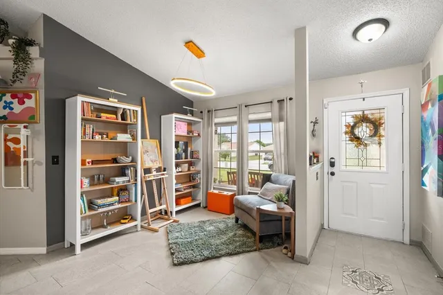 a living room with furniture and a book shelf
