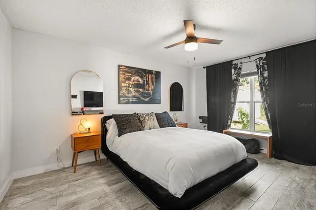 a large bedroom with a bed and a chandelier