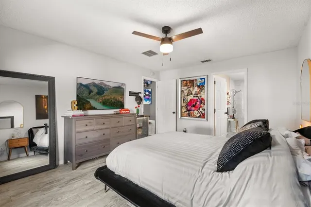 a bedroom with a large bed and a flat screen tv