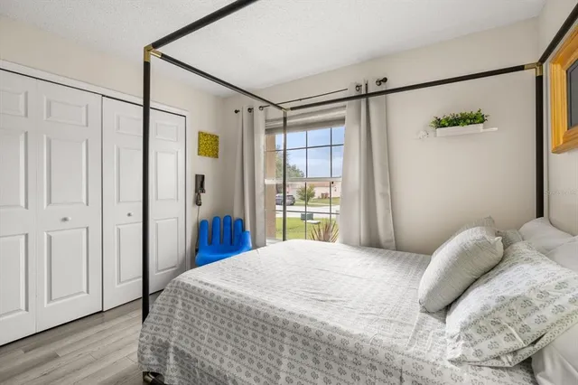 a bedroom with a bed and a window