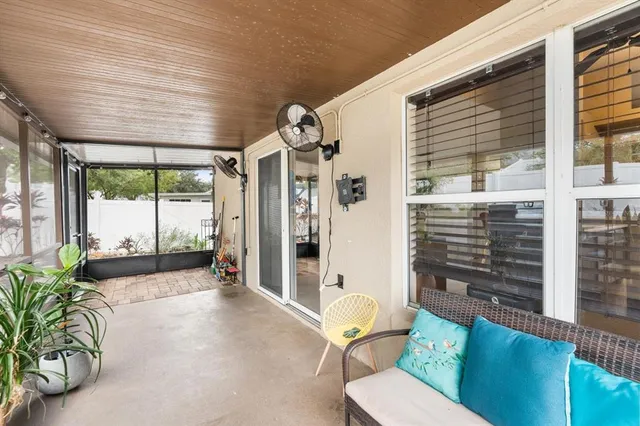 a porch with a table and chairs