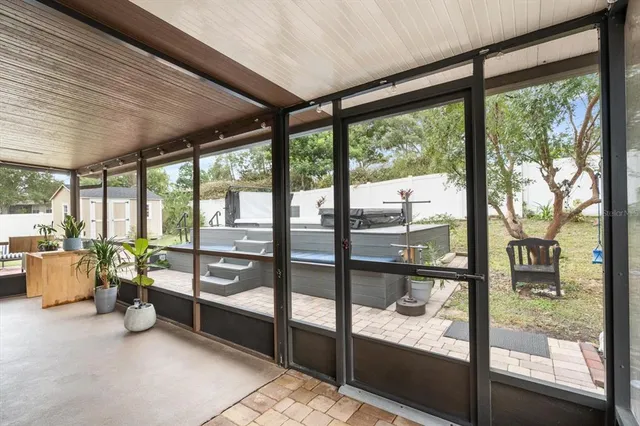 a bedroom with furniture and large windows