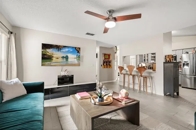 a living room with furniture and kitchen view