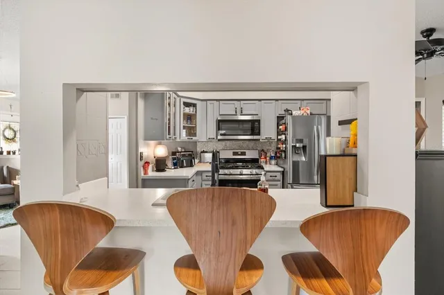 a living room with furniture and a kitchen