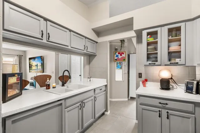 a kitchen with a sink and a refrigerator