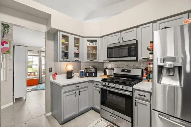 a kitchen with stainless steel appliances a stove microwave and a refrigerator