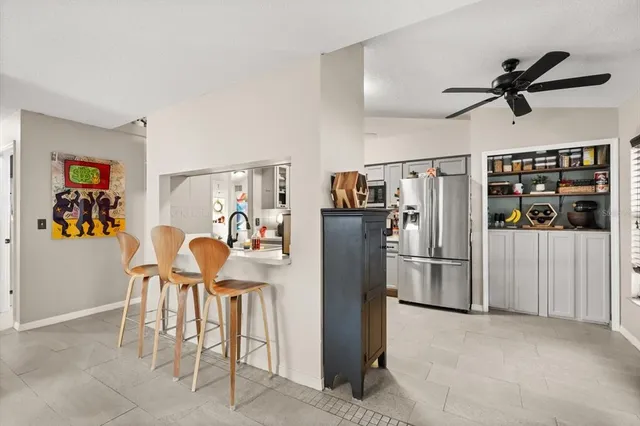 a dining room with stainless steel appliances furniture a refrigerator and washer