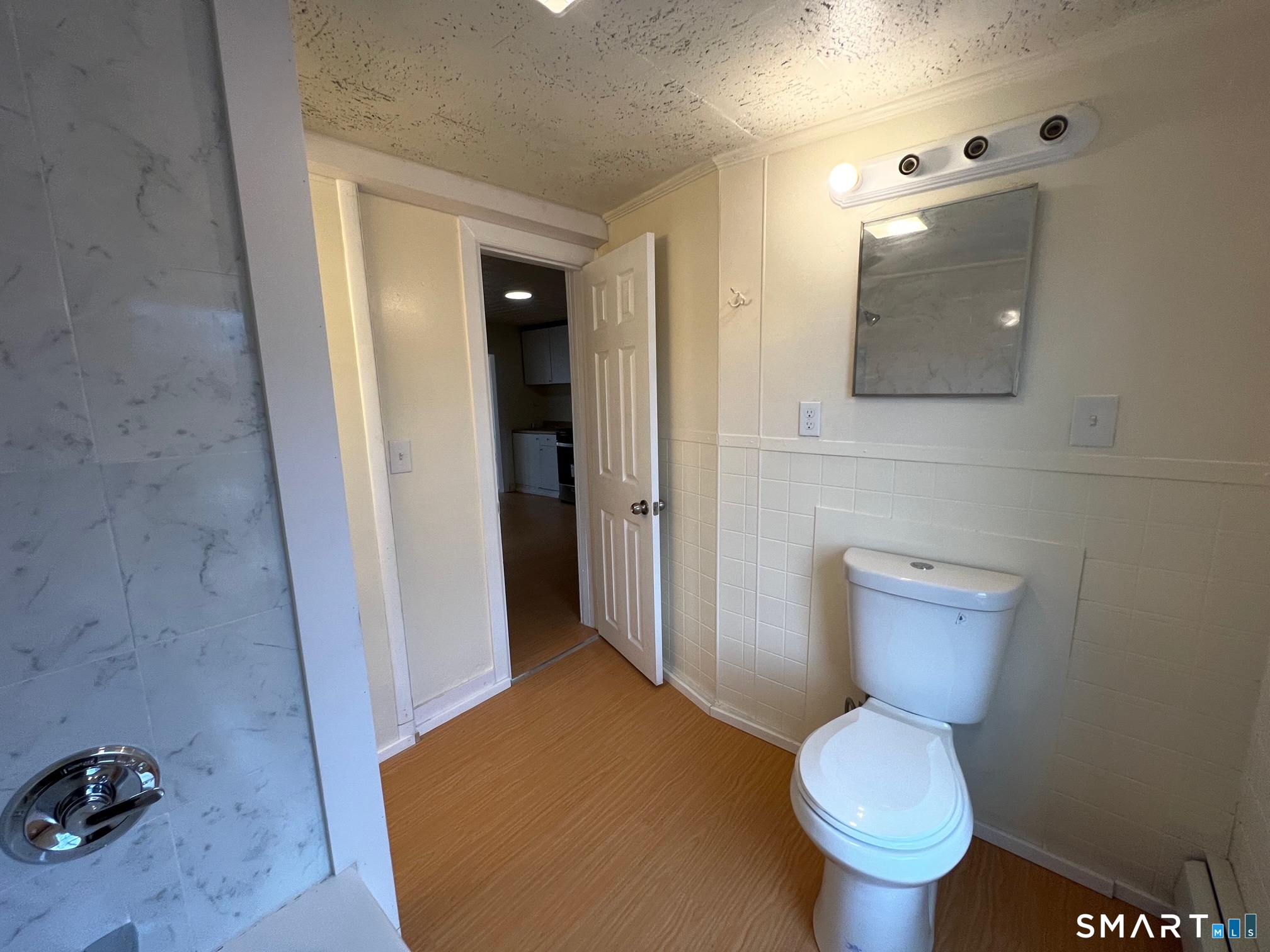 62 North Leonard Street Waterbury, CT 06708 - Photo 12 of 13 a bathroom with a toilet and a mirror