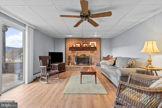 a living room with furniture a fireplace and a flat screen tv