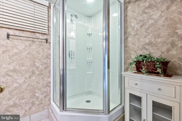 a bathroom with a shower and a mirror