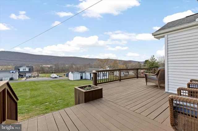 a view of a balcony with wooden floor and seating space