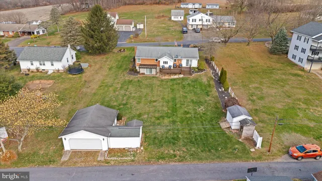 an aerial view of a residential houses with outdoor space