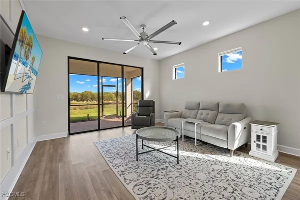 a living room with furniture and a large window
