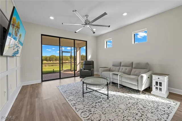 a living room with furniture and a large window