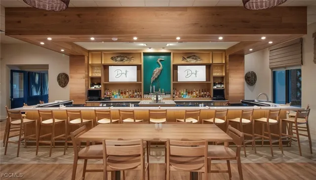 a large dining hall with stainless steel appliances a dining table and chairs