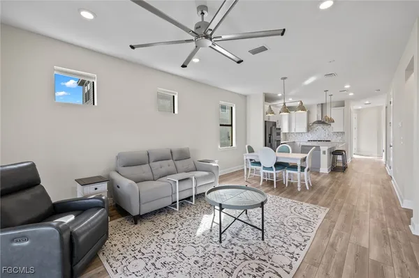 a living room with furniture and a wooden floor