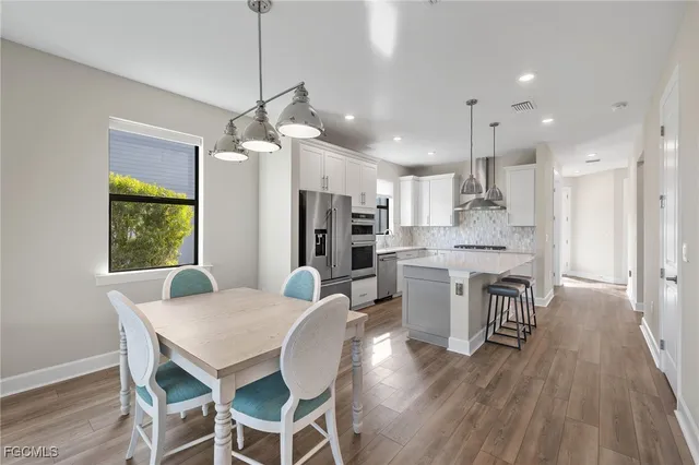 a view of a dining room with furniture window and wooden floor