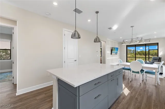 a large kitchen with a table and chairs