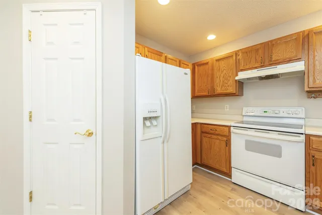 a kitchen with stainless steel appliances white cabinets and a refrigerator