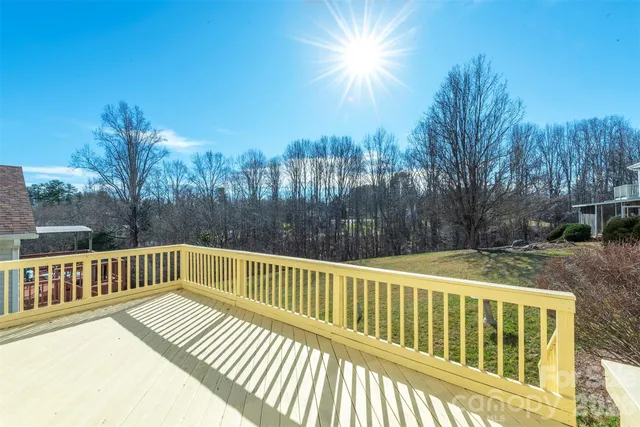 a view of balcony with wooden floor and fence
