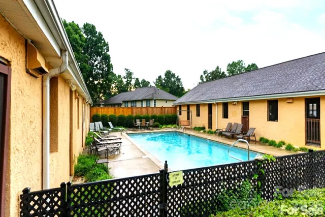 a view of a sign board with flower plants