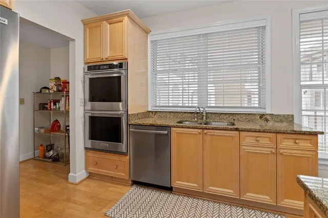 a kitchen with stainless steel appliances granite countertop a stove and a sink