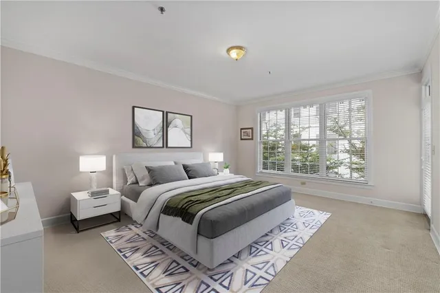 a bedroom with a large bed and a large window