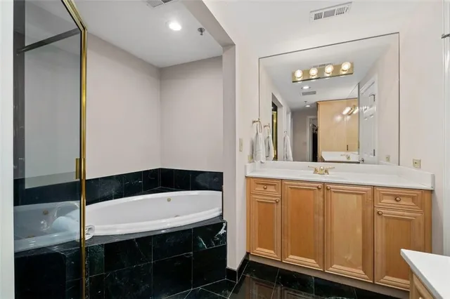 a bathroom with a sink a mirror and a bathtub