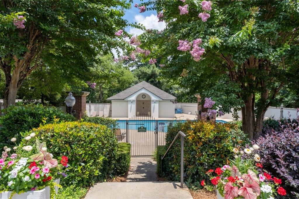 3101 Howell Mill Road Northwest, Unit 227 Atlanta, GA 30327 - Photo 29 of 48 a house with a flower garden in front of it