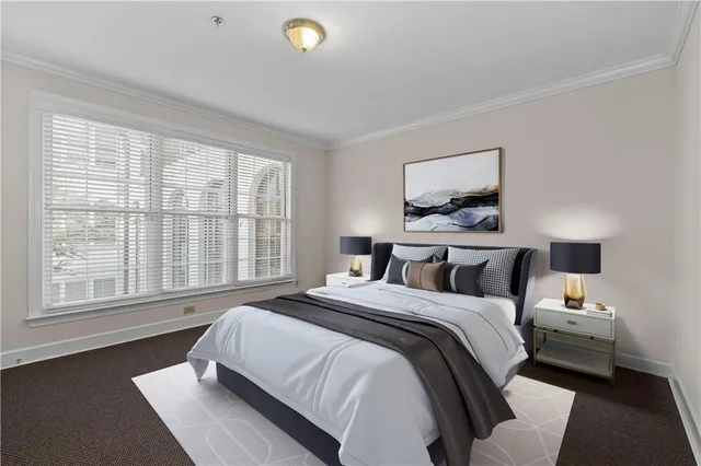 a bed sitting in a spacious bedroom next to a window