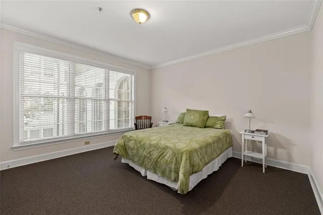 a spacious bedroom with a bed and a window