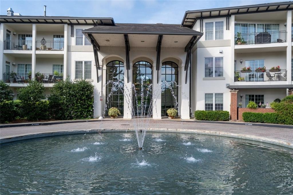 3101 Howell Mill Road Northwest, Unit 227 Atlanta, GA 30327 - Photo 32 of 48 a front view of a building with a garden