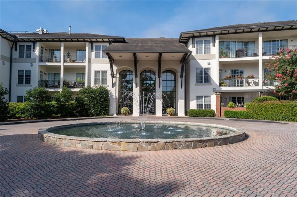 3101 Howell Mill Road Northwest, Unit 227 Atlanta, GA 30327 - Photo 33 of 48 a view of a white building with swimming pool in front of it